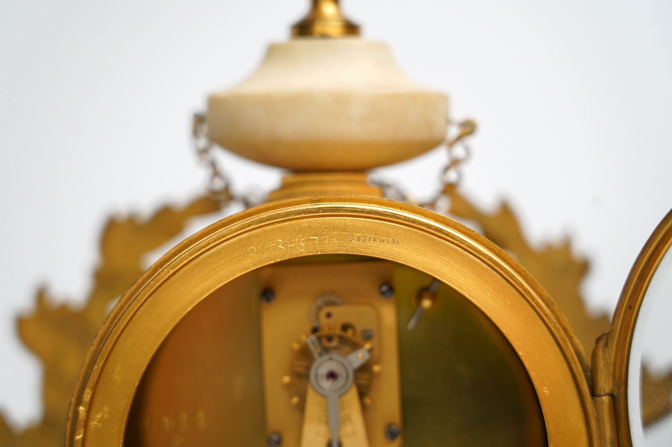 A late 19th century French alabaster and gilt metal timepiece with enamel dial, with key, 31cm high. Condition - fair